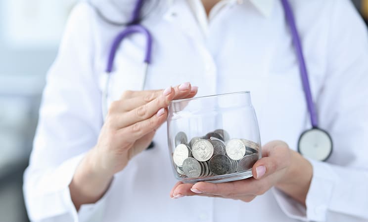 female nurse holding a jar with coins