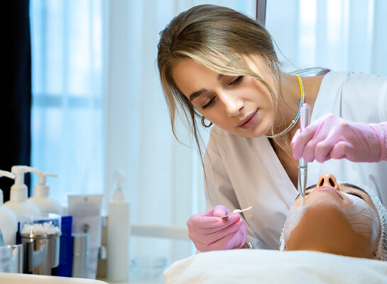 aesthetic nurse with pink gloves making a procedure